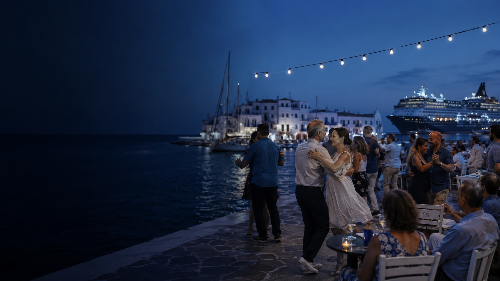 Adult social dancers enjoying an evening at a waterfront café in a Greek port, with a cruise ship across the marina